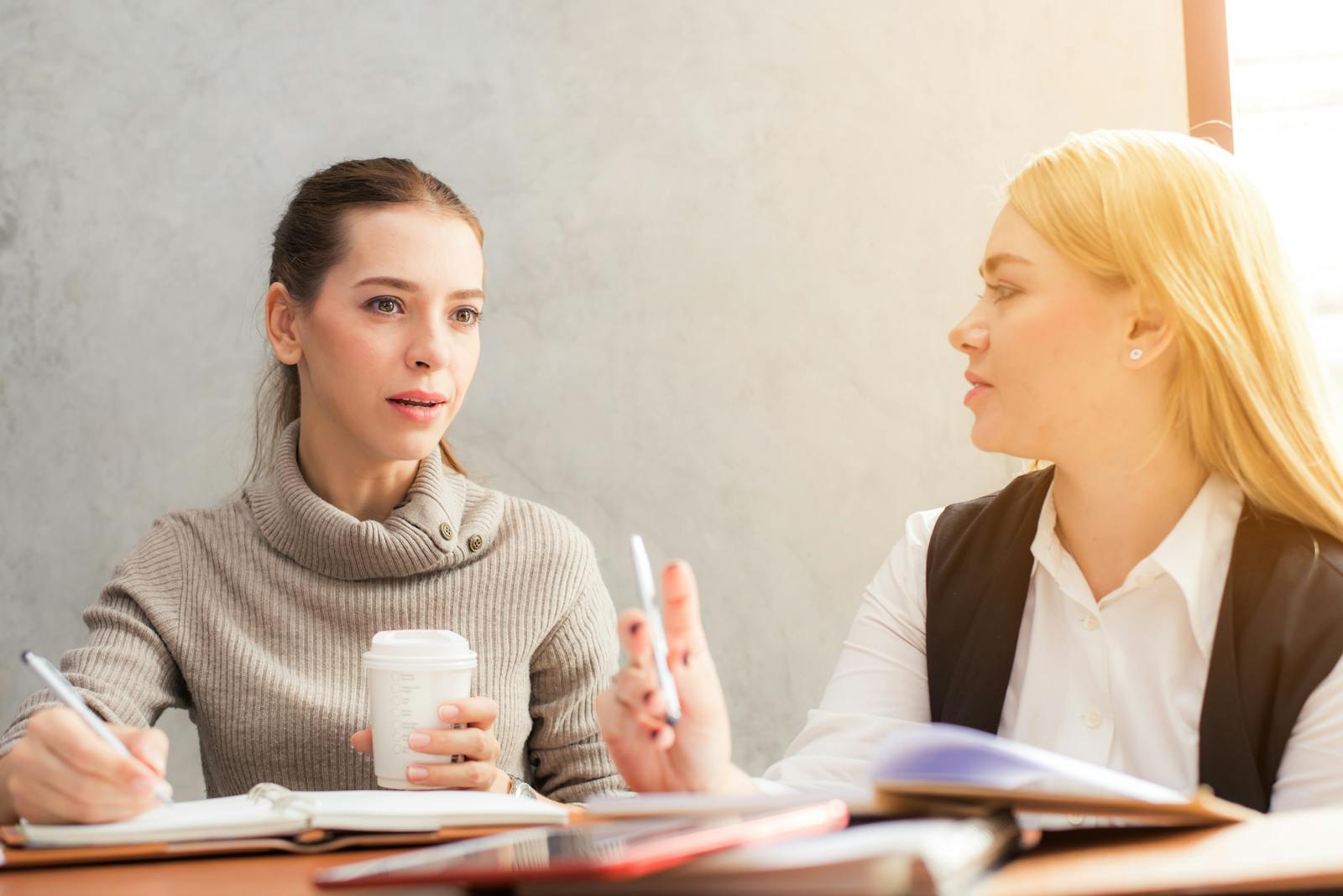Two Women Holding Talking