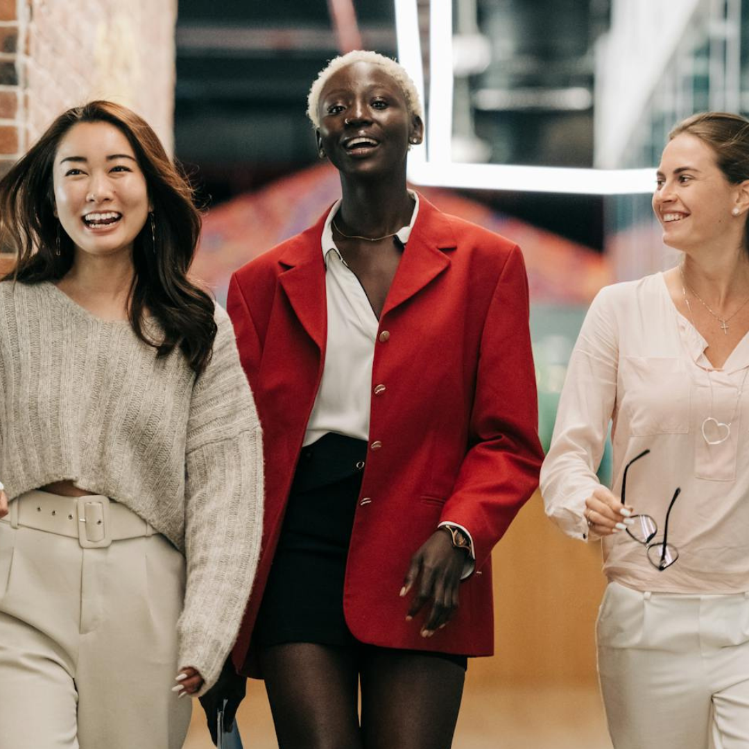 Professional women walking representing empowerment coaching for ambitious women.